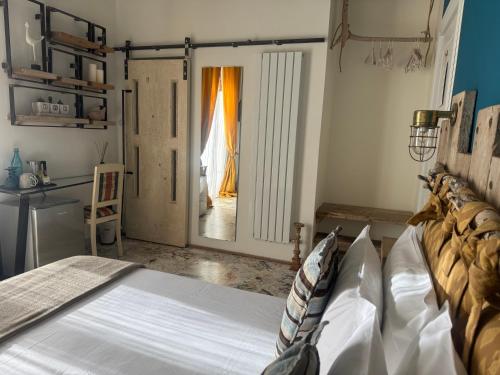 a bedroom with a bed and a door to a hallway at HABITARE Lecce & Salento in Lecce