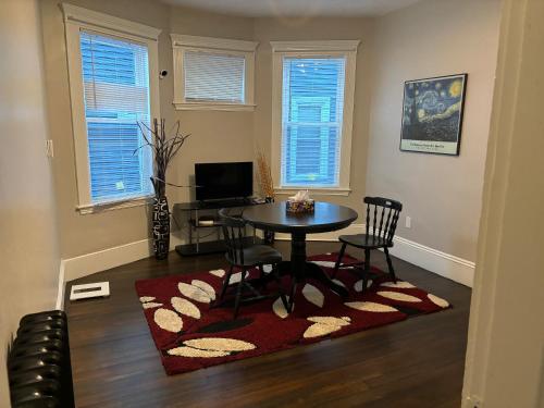 a dining room with a table and chairs in a room at HomeStay in Boston - Dorchester Fields Corner Area in Boston