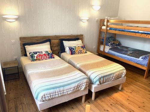 two beds in a room with two bunk beds at La cremaillère in Huriel