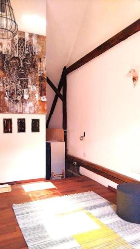 a room with a white wall and a wooden floor at allinhome in Klagenfurt