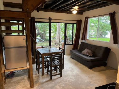 a living room with a table and a couch at Embajada Universal By La Eufemia Group in Huay Pix