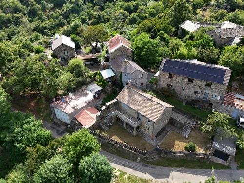 an aerial view of an old house with a solar roof at La Jeannette in Sablières