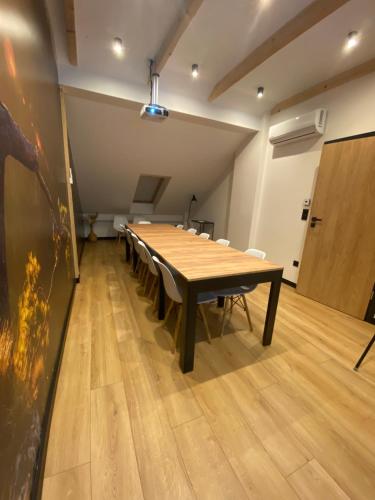 a large conference room with a wooden table in it at Willa Asia in Sromowce Niżne