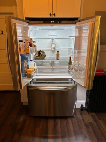 an empty refrigerator with its door open in a kitchen at HomeStay in Boston - Dorchester Fields Corner Area in Boston