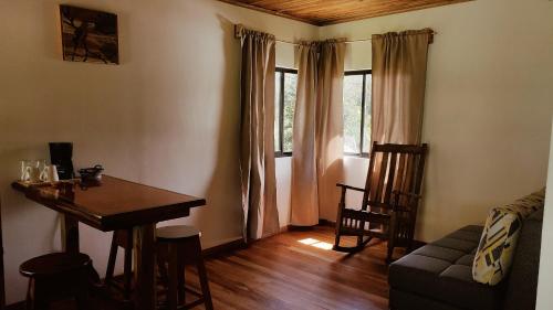 a living room with a table and a couch at Grand Luna - Monteverde in Tilarán