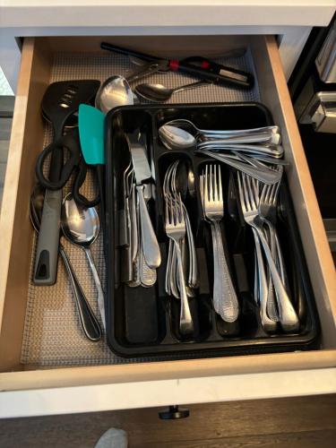 a drawer with forks and spoons and utensils at HomeStay in Boston - Dorchester Fields Corner Area in Boston