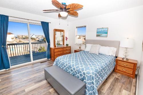 a bedroom with a bed and a large window at Oceanside, Close to Ocean, Grocery store and shopping! KD104, Cake by the Ocean in Kill Devil Hills