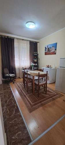 a living room with a wooden table and chairs at Apartamente Iosia in Oradea