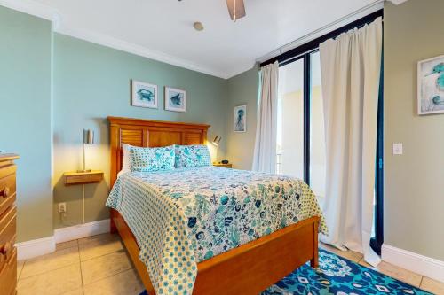 a bedroom with a bed and a large window at Holiday Isle 422 in Dauphin Island