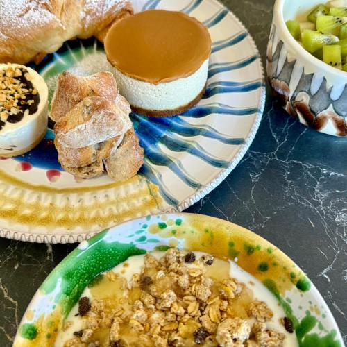 a table with two plates of food and a bowl of bread at HABITARE Lecce & Salento in Lecce