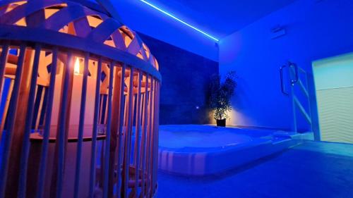 a blue room with a tub with a plant in it at Hotel Butterfly Wellness & Spa in Rimini