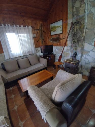 a living room with a couch and a table at Forest Home in Golubovci