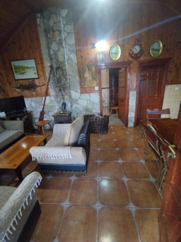a living room with a couch and a stone wall at Forest Home in Golubovci