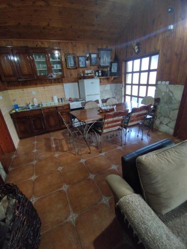 a kitchen and dining room with a table and chairs at Forest Home in Golubovci