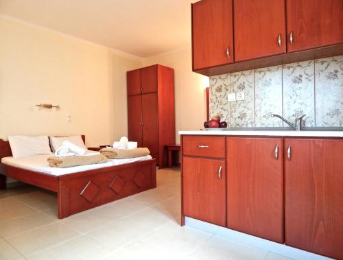 A bed or beds in a room at Panorama Apartments and Studios