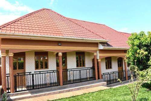 a house with a red roof at ADM Guest Houses in Rubirizi