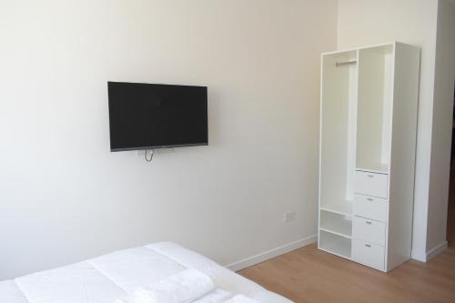 a bedroom with a tv hanging on the wall at Torrar Suites in Buenos Aires