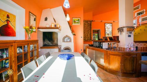 a dining room with a table and a kitchen at Villa Gambula - Relax and Pool in Perdaxius