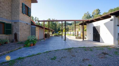 an empty courtyard of a house with a patio at Villa Gambula - Relax and Pool in Perdaxius