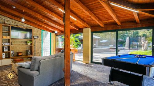 a living room with a pool table and a couch at Villa Gambula - Relax and Pool in Perdaxius
