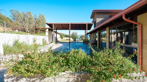 a building with flowers in front of a street at Villa Gambula - Relax and Pool in Perdaxius