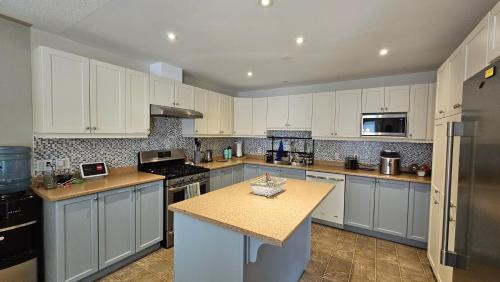 a kitchen with white cabinets and a counter top at Family Friendly 3 Bedroom Unit - Close to Downtown Kingston! in Kingston
