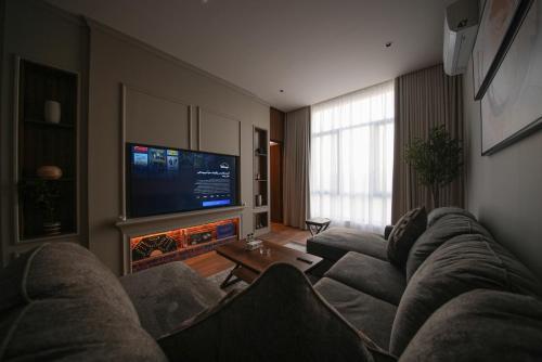 a living room with a couch and a fire place at Nma a Residences 2 in Riyadh