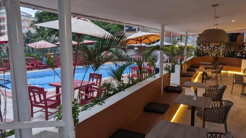 a restaurant with tables and chairs and a swimming pool at Westlands bliss By bliss haven in Nairobi