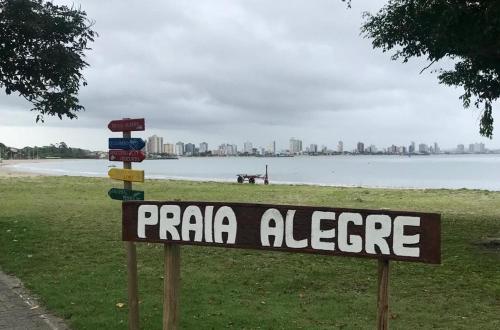 a sign that reads praia algeleznee in front of a beach at Casa 3 quartos com Piscina no centro de Penha - SC in Penha
