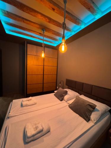 a bedroom with a bed with two towels on it at MERLIN Apartments in Zamość