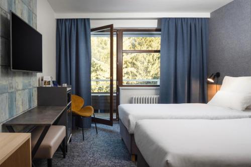 Postel nebo postele na pokoji v ubytování OREA Resort Devět Skal Vysočina