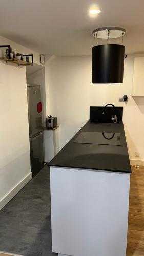 une cuisine avec un comptoir noir et blanc dans l'établissement Appartement au port de Nice, proche des plages, à Nice