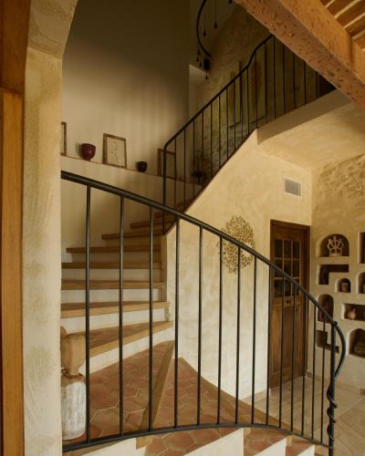 a staircase with black railings in a house at LA BASTIDE DES CULS-ROUSSET in Marseille