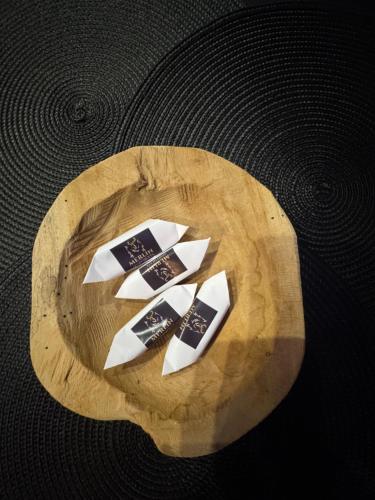 three pieces of paper on top of a wooden table at MERLIN Apartments in Zamość