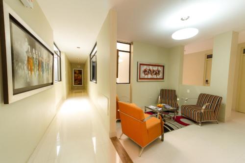 a living room with two chairs and a table at El Principe Hoteles in Piura