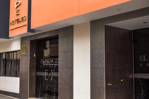 a facade of a building with two glass doors at El Principe Hoteles in Piura
