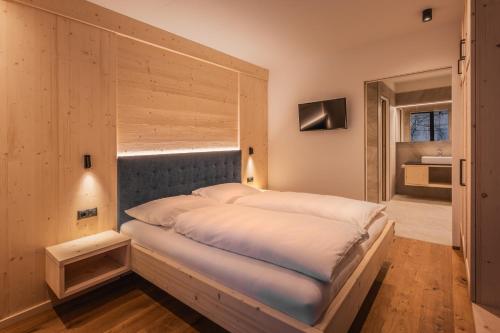 a large bed in a room with a window at A-Lunis in Brunico