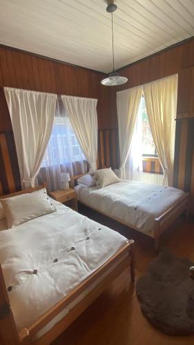a bedroom with two beds and a window at Hostal de Campo in Ensenada