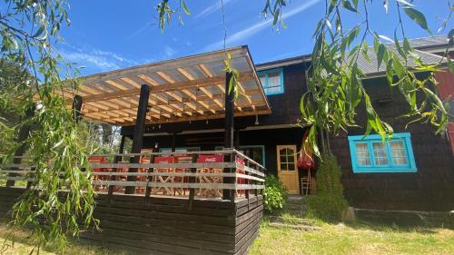 a house with a pergola in front of it at Hostal de Campo in Ensenada
