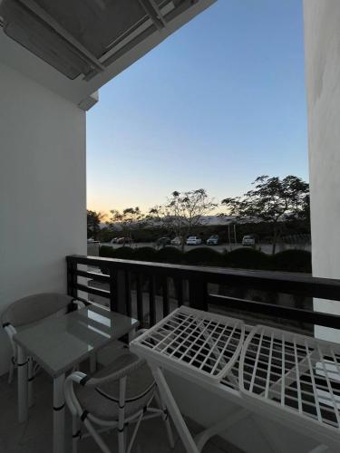 a balcony with a table and a table and chairs at Jasmine Resort & Aqua park in Sharm El Sheikh