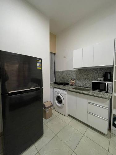 a kitchen with a black refrigerator and a dishwasher at Jasmine Resort & Aqua park in Sharm El Sheikh