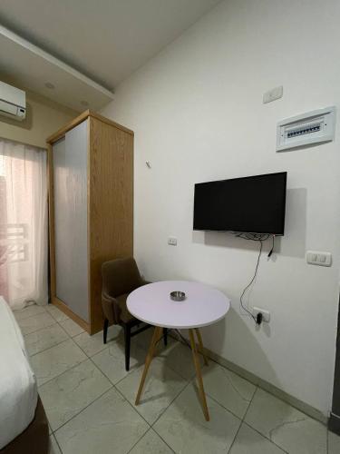 a room with a table and a tv on a wall at Jasmine Resort & Aqua park in Sharm El Sheikh