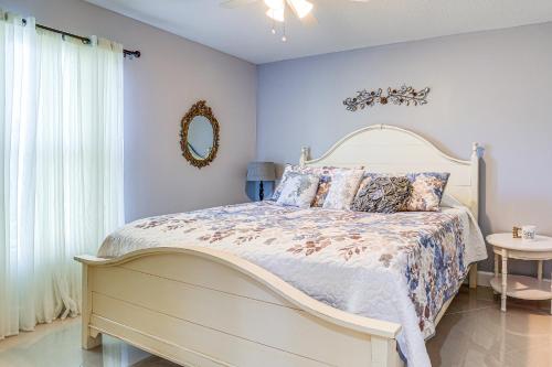 a bedroom with a large bed and a mirror at Near Parks Port St Lucie Home with Private Pool! in Port Saint Lucie