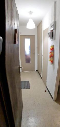 a hallway of an office with a door and a window at La marmotte in La Bresse