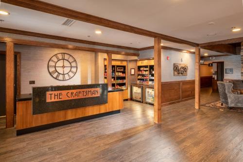 a lobby with a sign that reads the gathering at The Craftsman Inn & Suites in Fayetteville