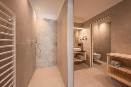 a bathroom with a shower and a toilet at A-Lunis in Brunico