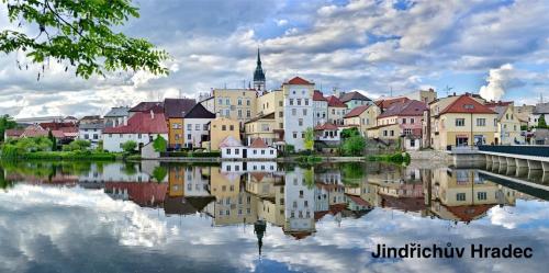 a city with a reflection in a body of water at Chalupa u Marušky in Český Rudolec