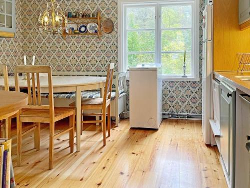 a kitchen with a table and chairs and a dining room at 6 person holiday home in LOFTAHAMMAR-By Traum in Loftahammar