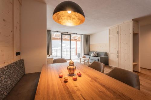 a dining room with a wooden table in a room at A-Lunis in Brunico
