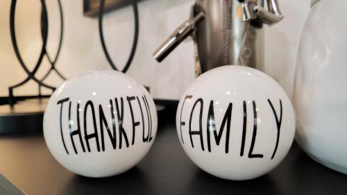 two white balls with black writing on them on a table at Relax Near Chattanooga at cozy Magdelaine House in Fort Oglethorpe